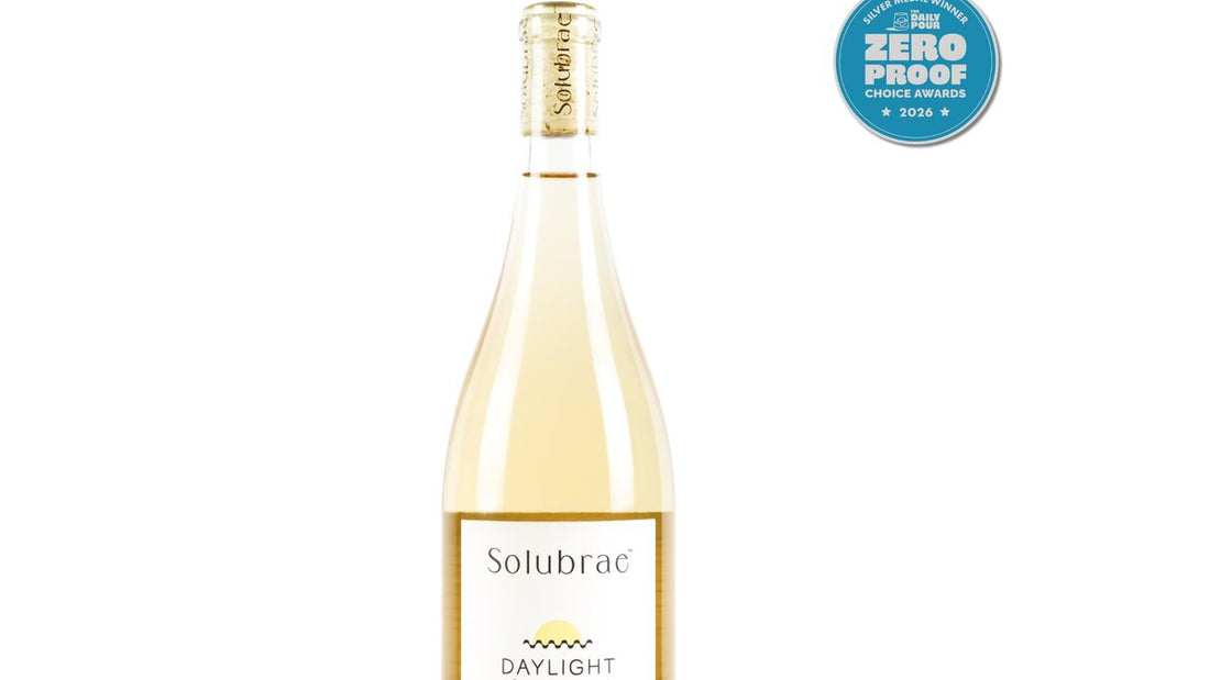 Solubrae Daylight bottle served cold in a wine glass with a dinner setting