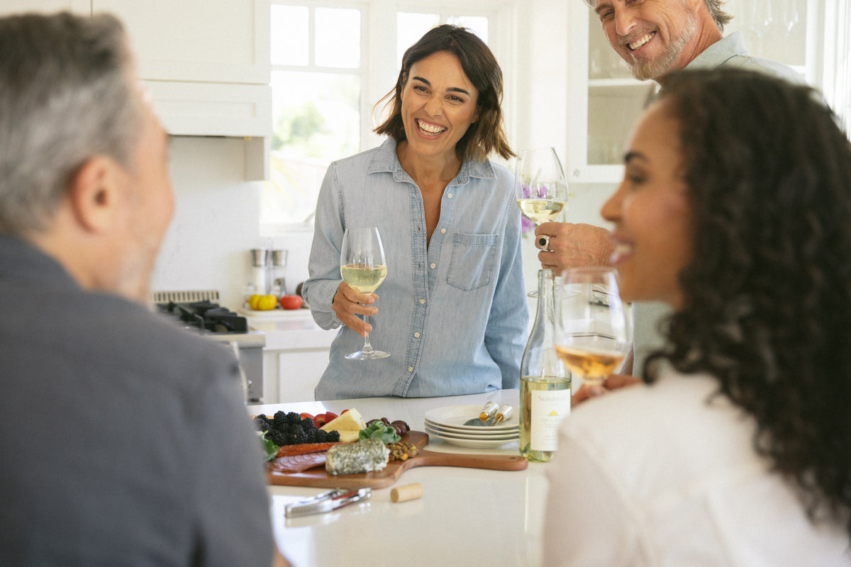 Non-alcoholic wine bottles on a dinner table for a Solubrae bundle comparison